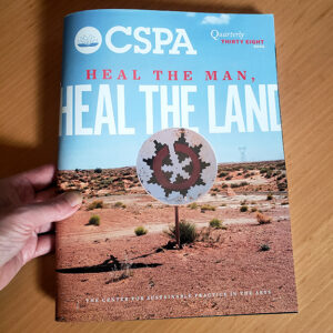 magazine with desert landscape on cover text is heal the land